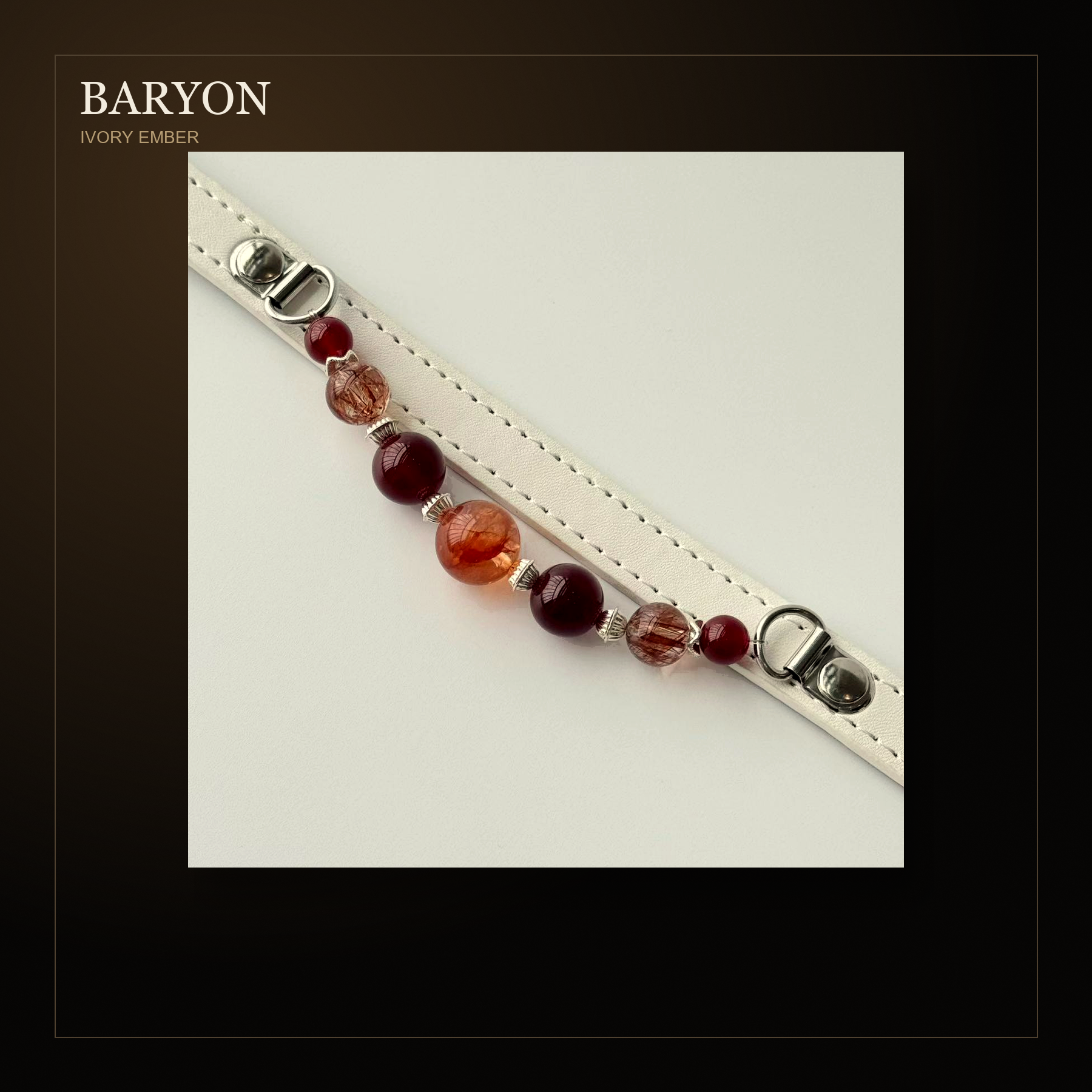 BARYON Ivory Ember dark editorial product card showing contrast between ivory leather and ember stones