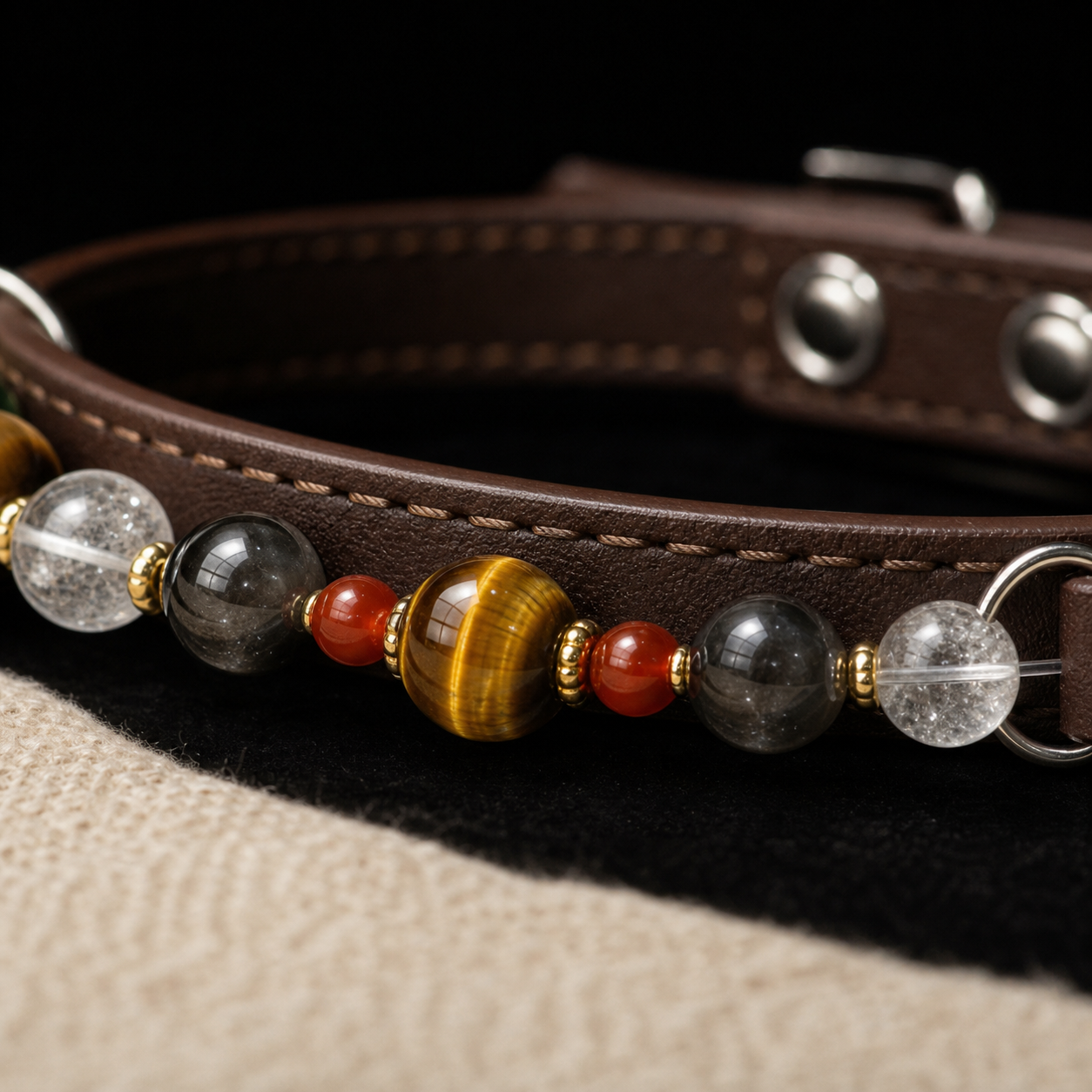 Macro detail of BARYON Still Signal brown leather, tiger eye, clear quartz, smoky beads, red agate, and gold spacers